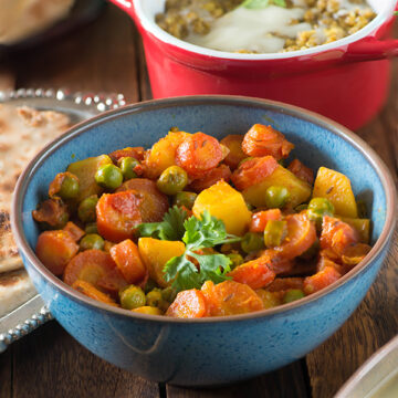 Aloo Gajar Matar recipe without onion and garlic. This is a Punjabi style dry sabzi made with very few spices and new potatoes, fresh peas, and winter red carrots.