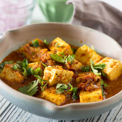Paneer Balti Masala is a very popular dish of Indian and Pakistani restaurants in Britain. Fresh soft chunks of paneer in a bucket of spicy tomato gravy. This is a semi rich paneer curry made with freshly toasted and ground whole spices served in a cast iron wok called Balti.
