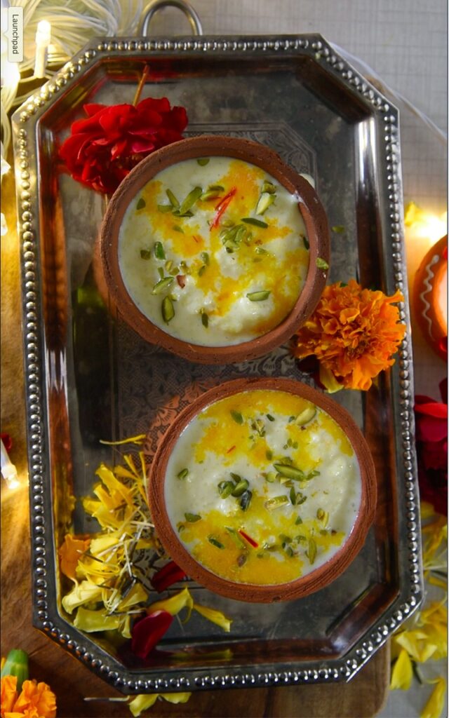 kesar phirni served in earthen bowls placed on silver tray