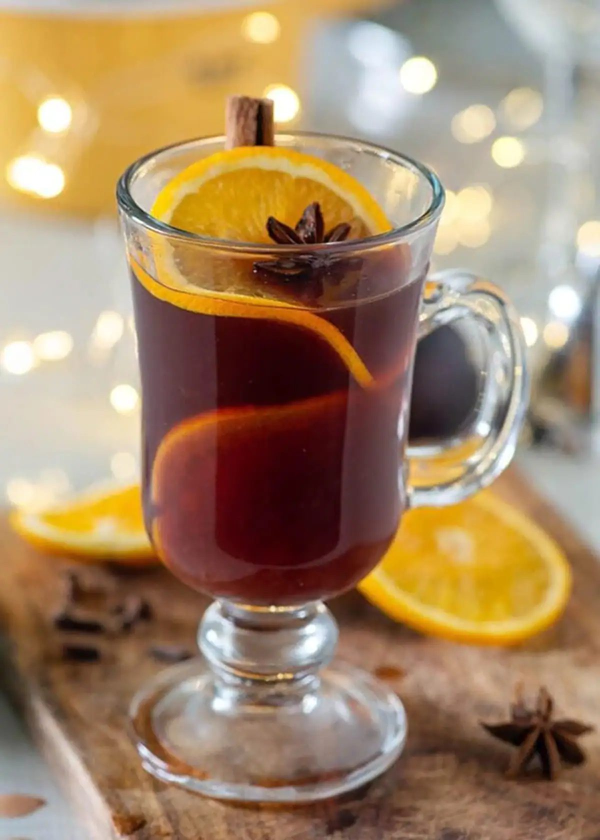 Steam-kissed glass mug of deep-red mulled wine glühwein