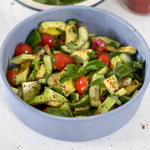 avocado salad served in a grey bowl on table