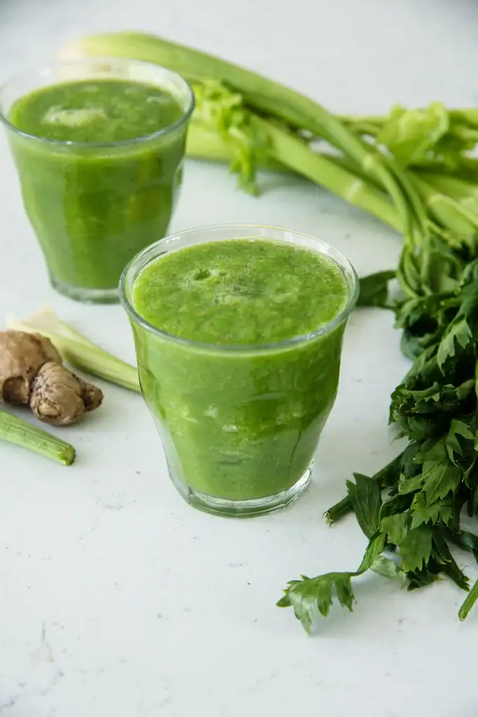best detox smoothie for weight loss in a glass with apple spinach and celery